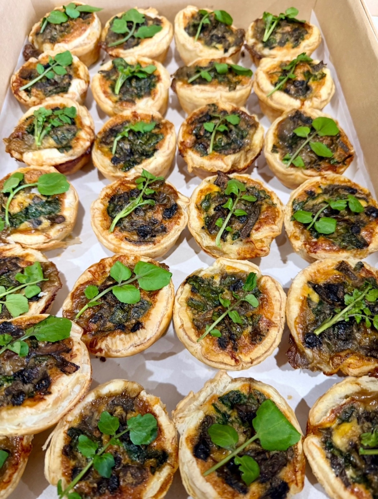 Fresh savoury tarts topped with leafy herbs