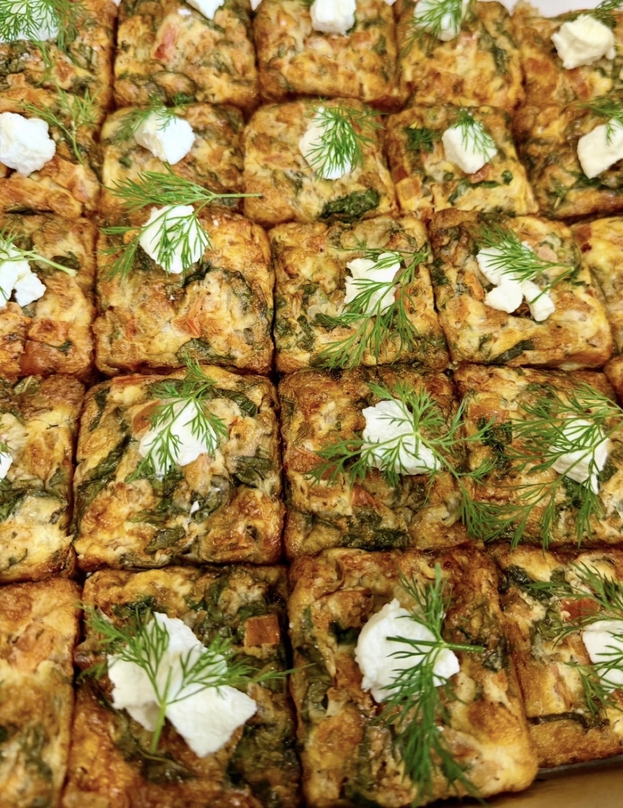 Savoury frittata squares topped with cheese and dill