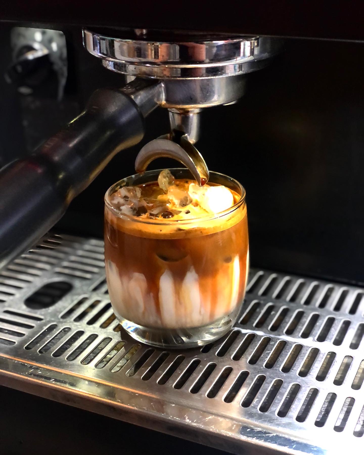 Fresh espresso pouring over ice and milk at Blackbird